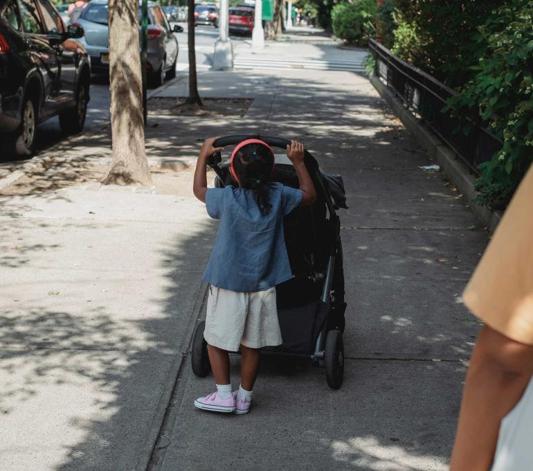 Image of a child pushing a stroller