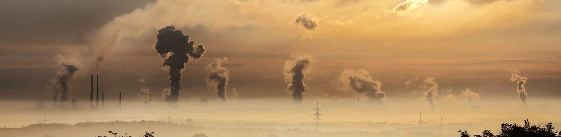 A row of smokestacks emitting air pollution
